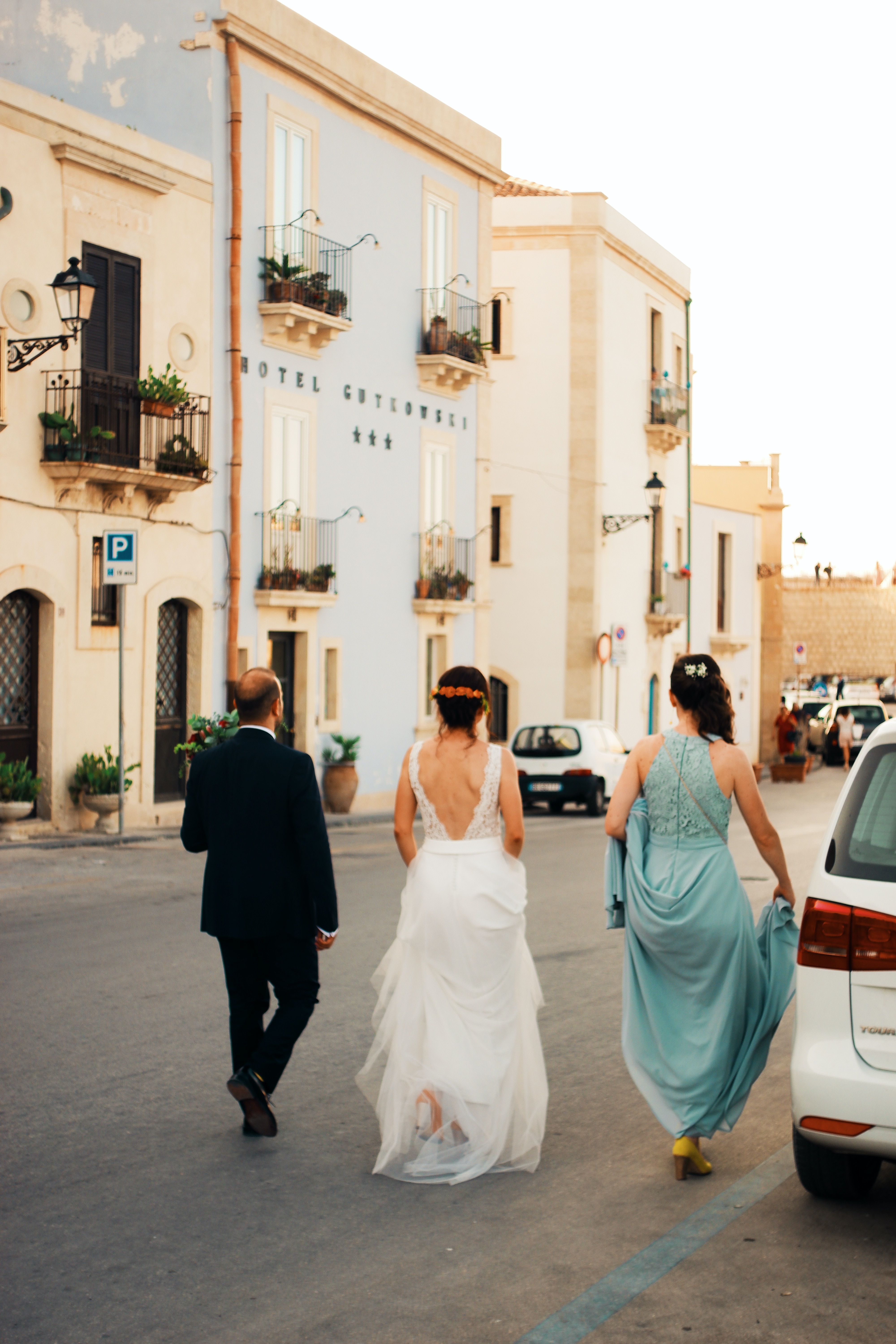 A summer wedding in Italy, newlywed couple bride and groom with bridesmaid