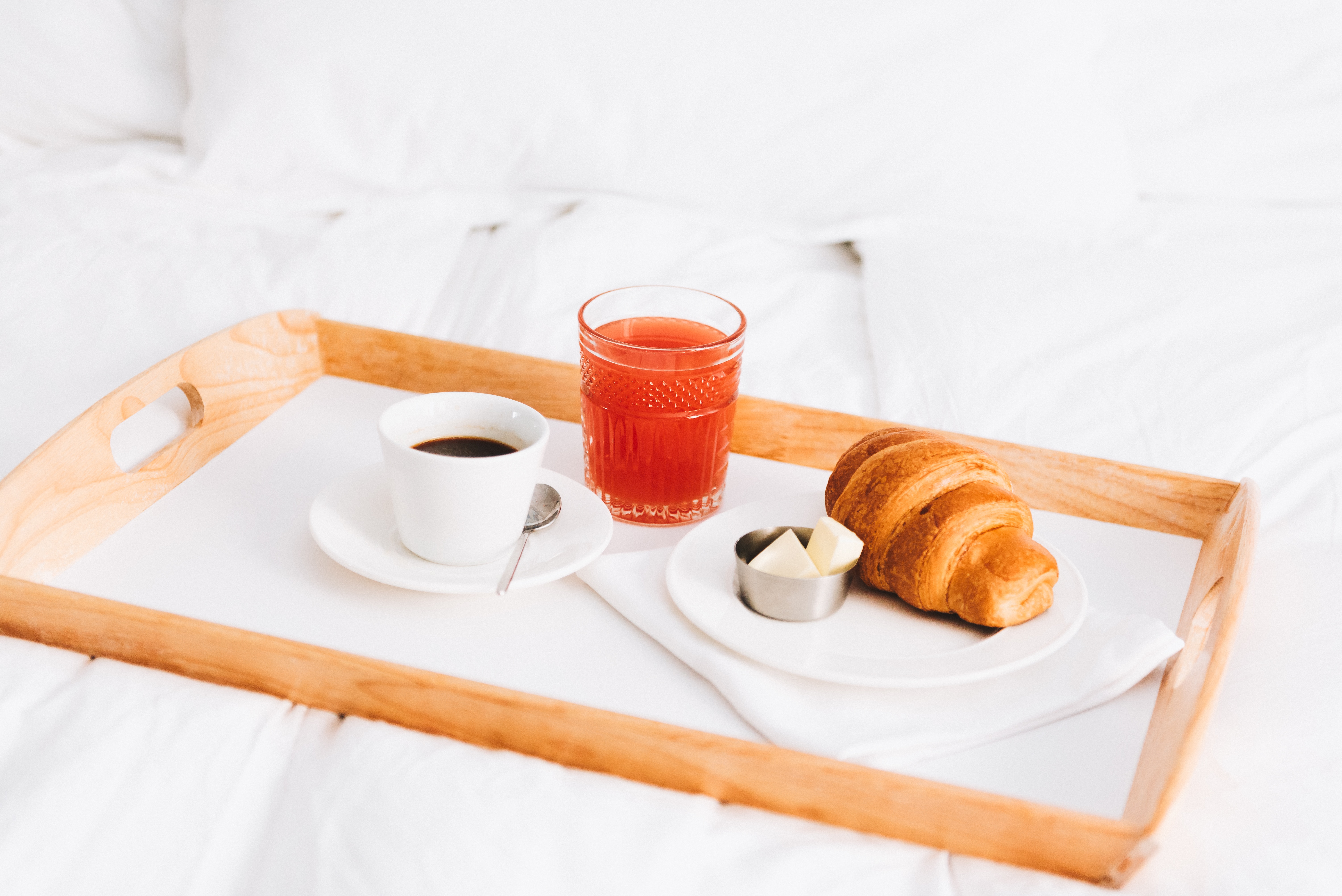 Perfect delicious breakfast of croissant with butter, coffee and grapefruit fresh juice 