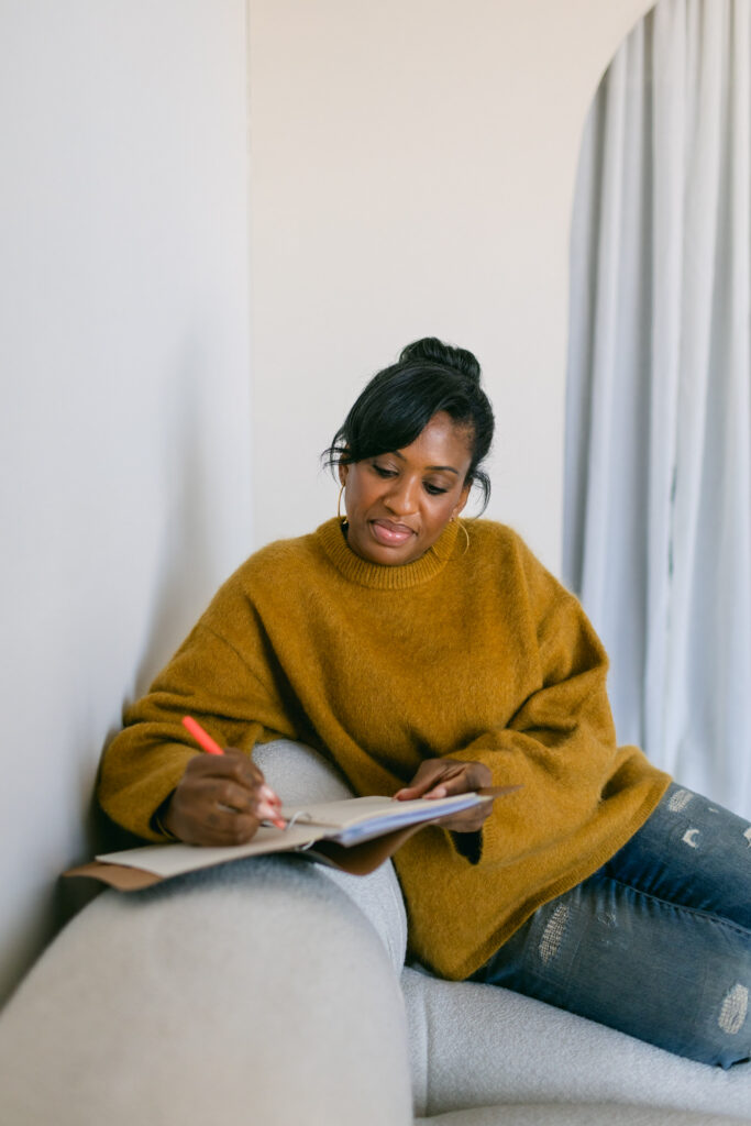 Image of the owner of Perfectly Planned 4 You, Cherelle writing in a notebook